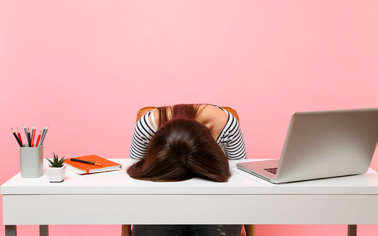 Woman with her head lying on her desk